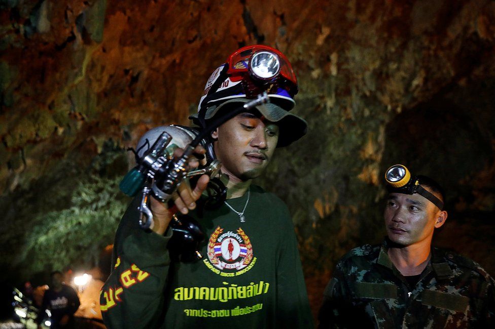 Soldiers and rescue workers work in Tham Luang cave complex