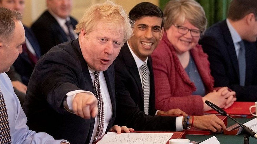 Boris Johnson addressing his new cabinet, with Chancellor Rishi Sunak sitting on his right