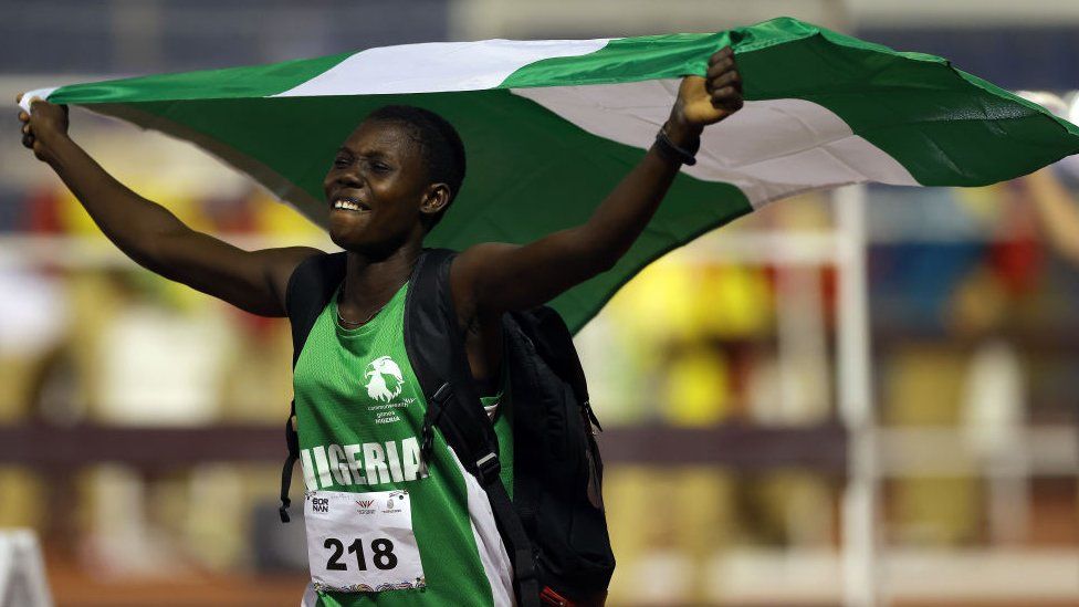 Woman holding Nigerian flag, 7 August 2023