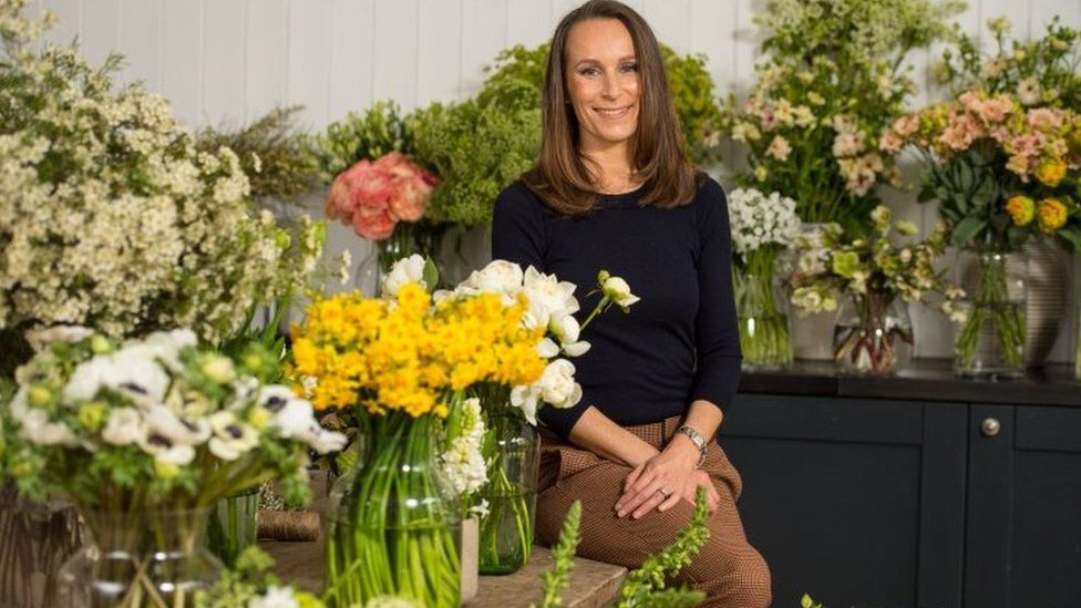 Florist Philippa Craddock surrounded by flowers