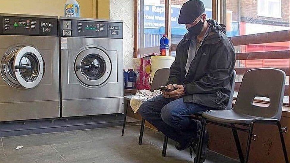 Man waits in launderette