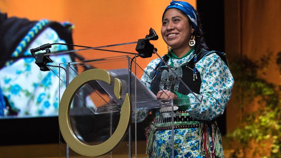 Belén Curamil Canio accepts the Goldman prize award on behalf of her father, Alberto
