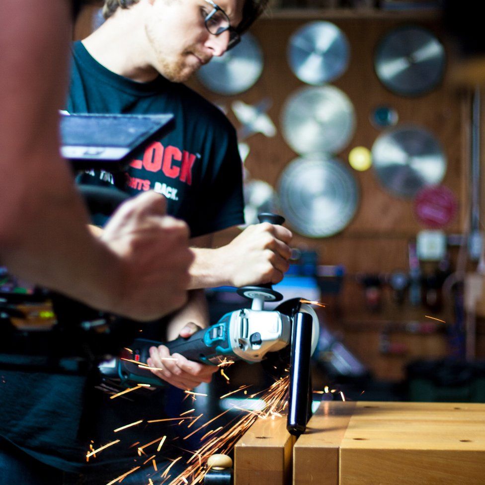 Daniel, one of the co-founders, shown attempting to cut through the Skunklock prototype with an angle grinder