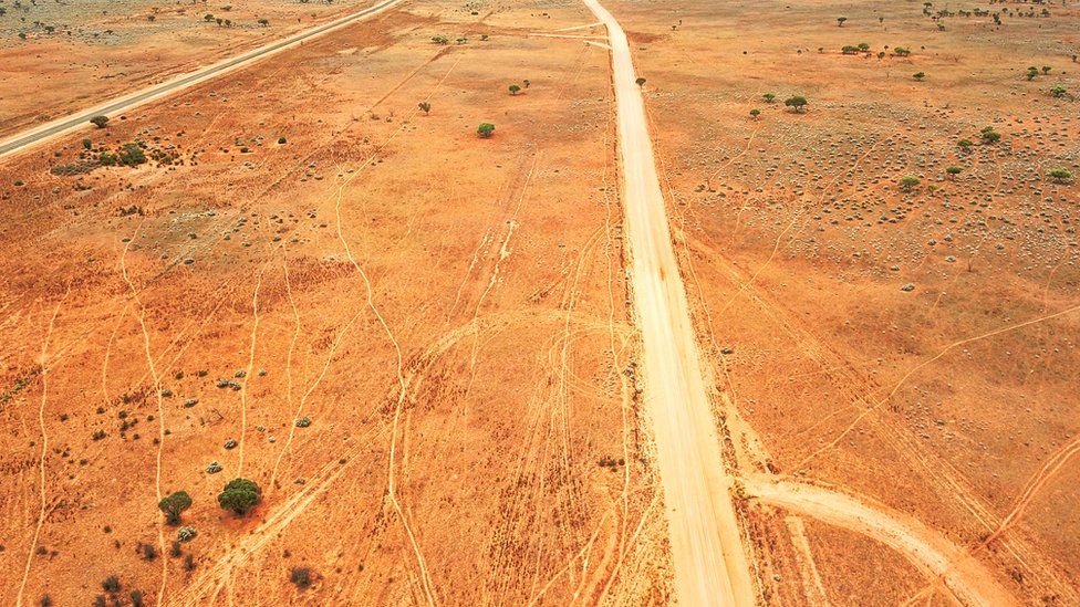 A deserted dirt road in the Australian outback, seen from above