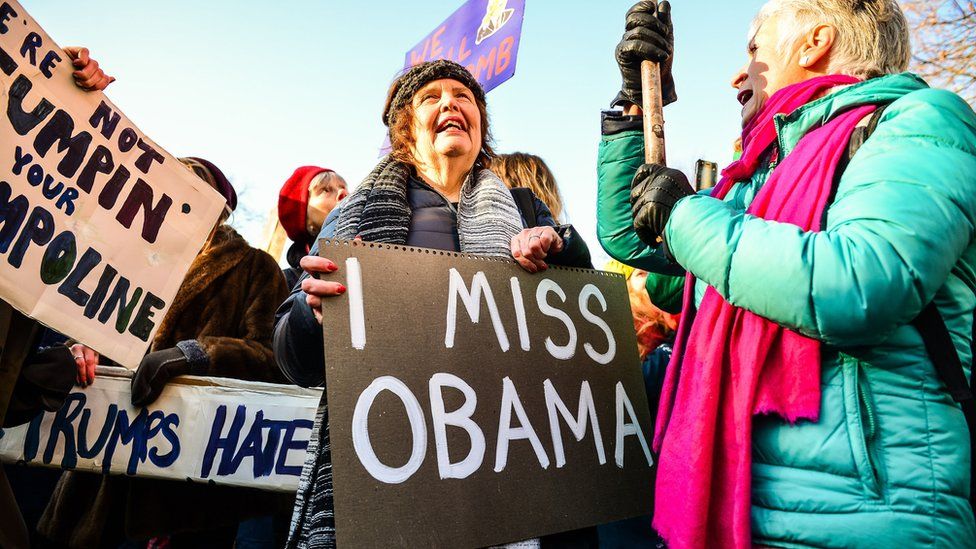 Woman holding a sign in London saying 'I miss Obama' - 21 January 2017