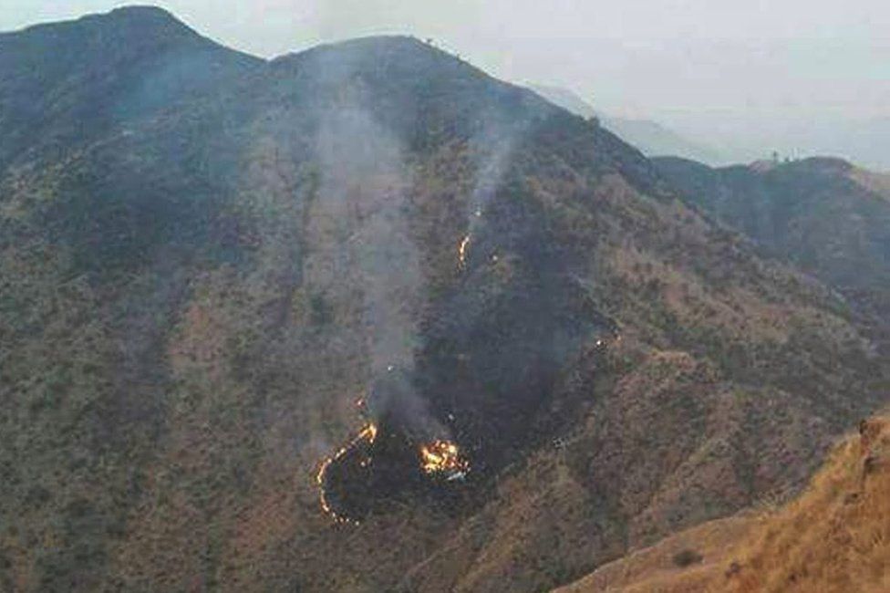 Flames rise from the wreckage of a Pakistan International Airlines (PIA) ATR 42 turboprop passenger plane after it crashed near Abbottabad, Pakistan, 7 December 2016.
