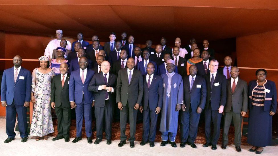 Ivory Coast' Prime Minister Amadou Gon Coulibaly (C), French Economy and Finance Minister Michel Sapin (C,L) and African Ministers of Finances pose after the opining ceremony of African Financial Community (CFA) Franc zone ministers' meeting on April 14, 2017 in Abidjan.