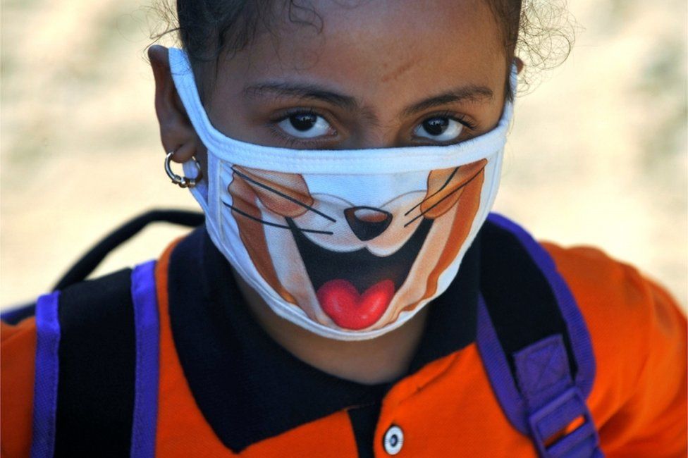 A student wearing a protective face mask attends the first day"s class at El Safa school, following months of closure due to the coronavirus disease (COVID-19) outbreak in the Giza suburb of Awsim, Egypt October 18, 2020.