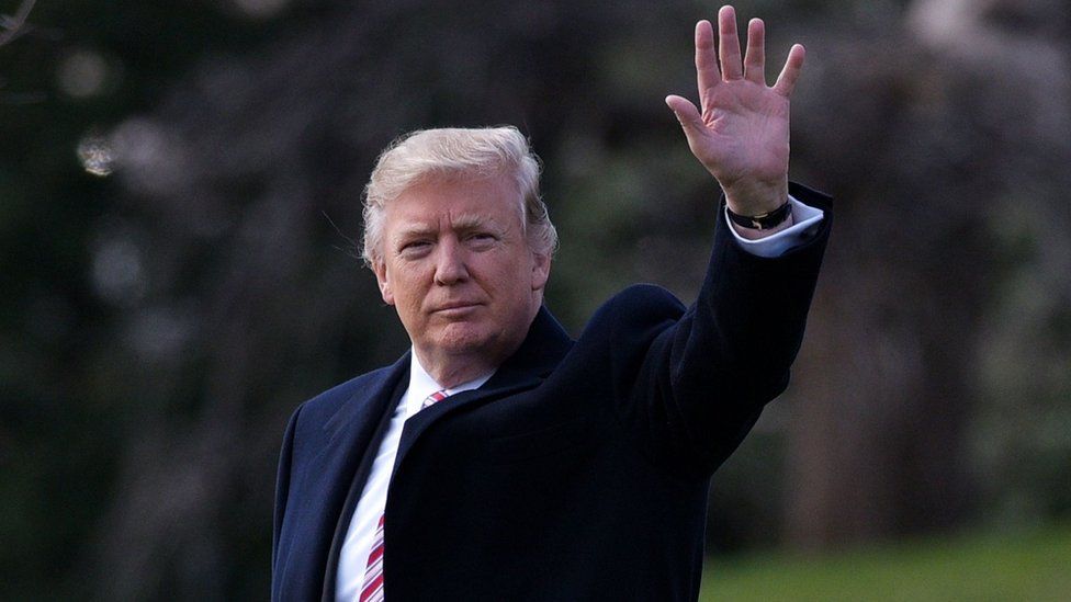 Donald Trump waves as he crosses the South Lawn of the White House to board Marine One, 2 March 2017