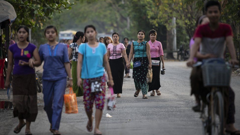 Women workers leave a factory outside Yangon, Myanmar