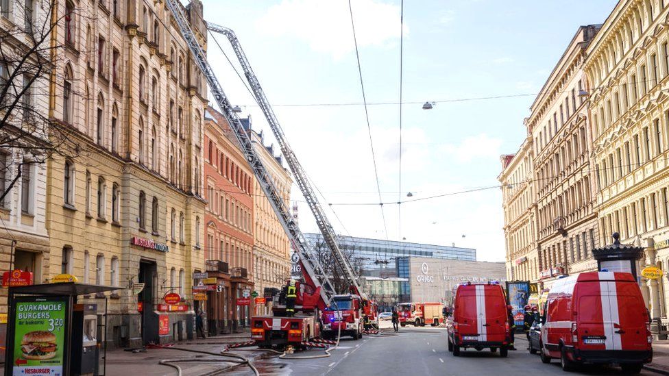Firefighters work at the site of a blaze in the city centre of Riga, Latvia, 28 April 2021.