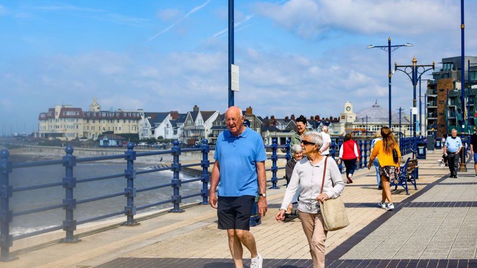 Couple walk along Porthcawl seafront