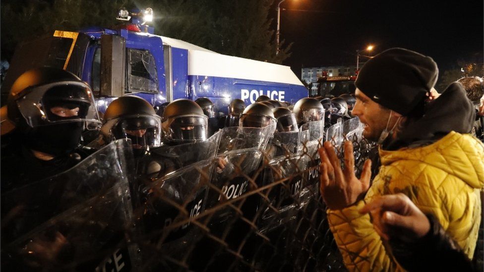 A protester faces a line of riot police in Tbilisi, Georgia