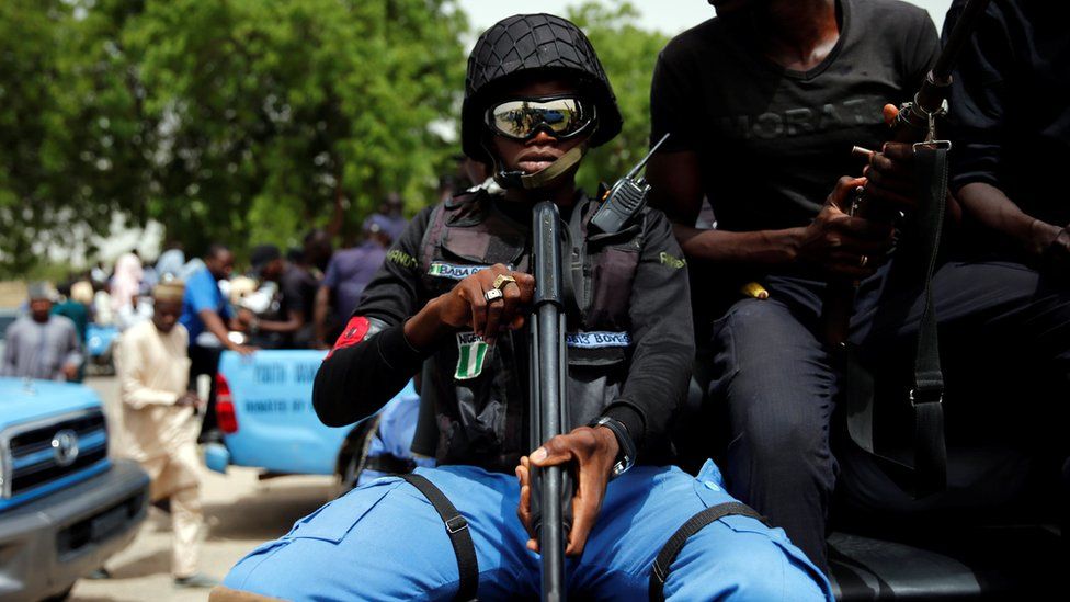 A member of the local militia, otherwise known as CJTF, Baba Gana, holds a gun as he sits in the back of a truck during a patrol in the city of Maiduguri, northern Nigeria June 9, 2017.