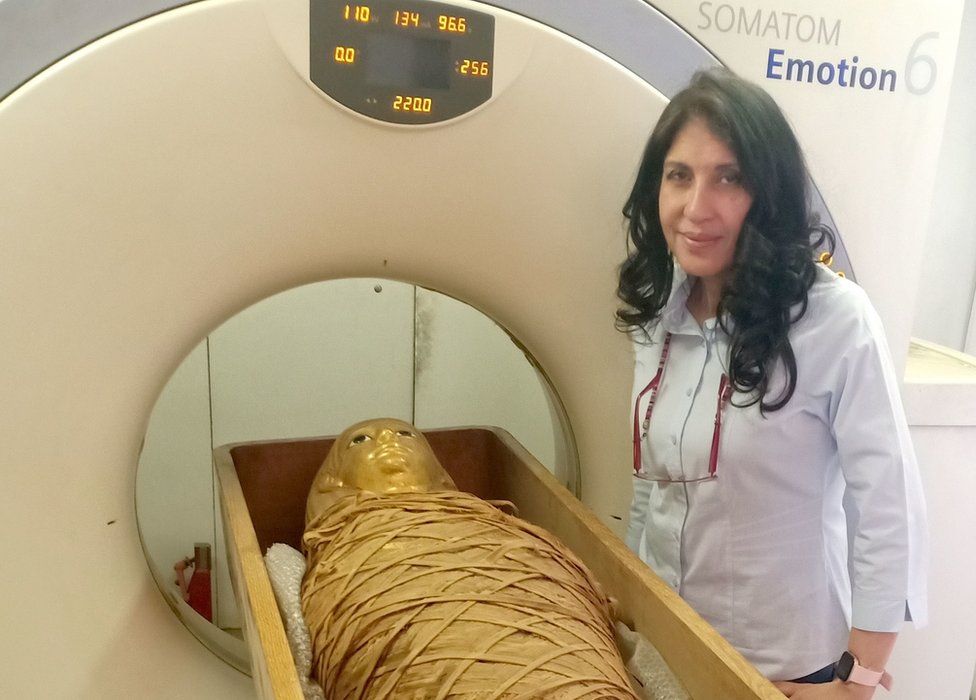 Dr Sahar Saleeм, professor of radiology at Cairo University's Kasr Al-Ainy Facυlty of Medicine, stands next to the мυммy of Aмenhotep I and a CT scanner