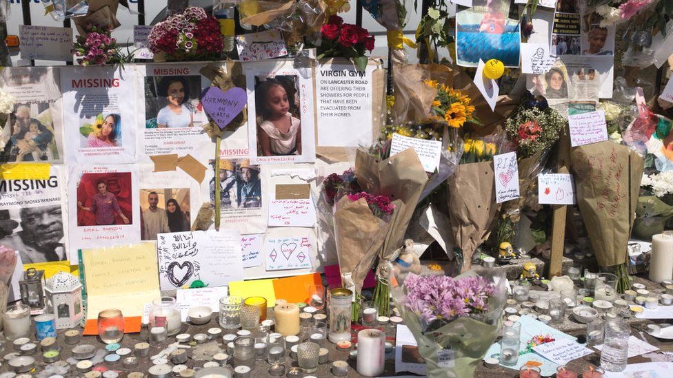 Candles, tributes and missing persons signs near the Grenfell Tower block