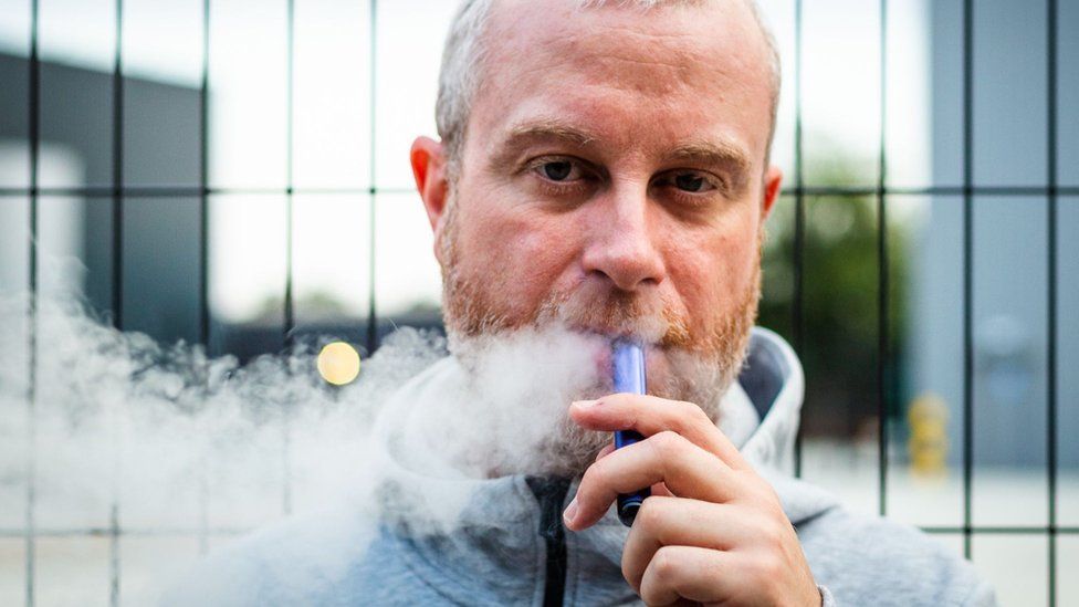 Man smoking disposable vape