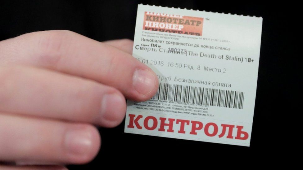 A man holds a ticket of the "Death of Stalin" movie, which was banned from being shown in cinemas of the country on January 24, as he attends its screening at the Pioner Cinema in Moscow, Russia