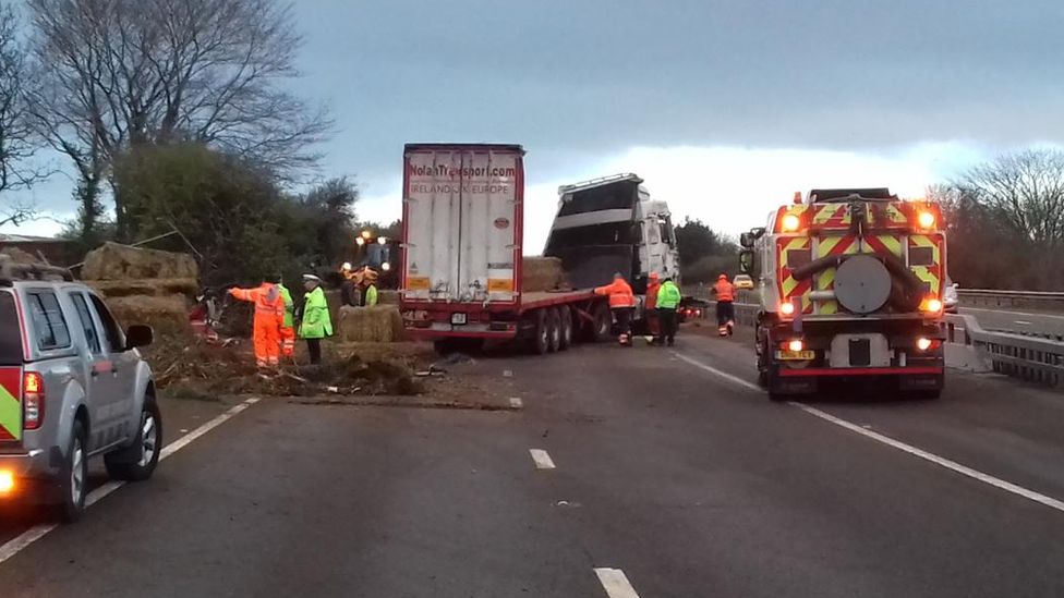 A lorry being recovered from the A55