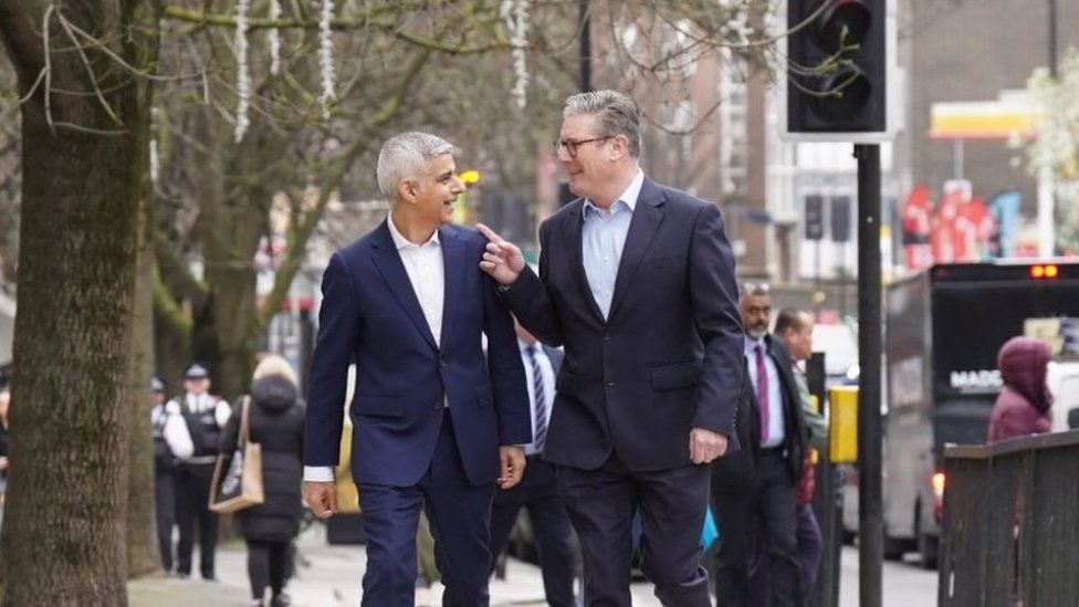 Sadiq Khan and Sir Keir Starmer laugh as they leave Mr Khan's launch event in Westminster