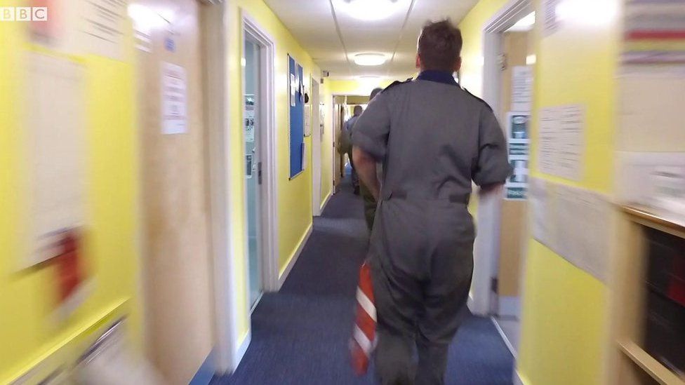 RAF personnel running in corridor