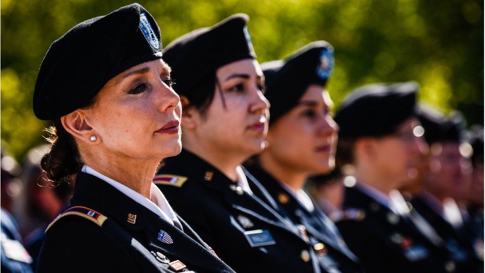 Chief Warrant Officer Four, Rosemary Masters, of Oklahoma Army National Guard, left, listens to the speaker during the 20th Anniversary of Women In Military Service For America Memorial celebration on Saturday, October 21, 2017, at the Arlington National Cemetery in Arlington, VA.