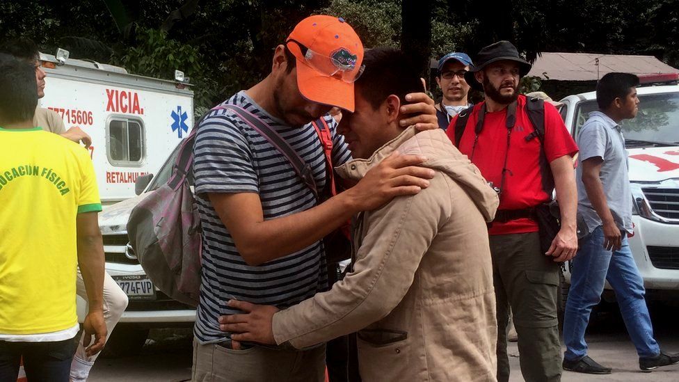 Boris Rodriguez is comforted after the volcano near-destroyed his village