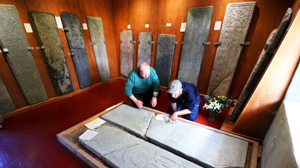 Examining gravestones at Kiel in Argyll