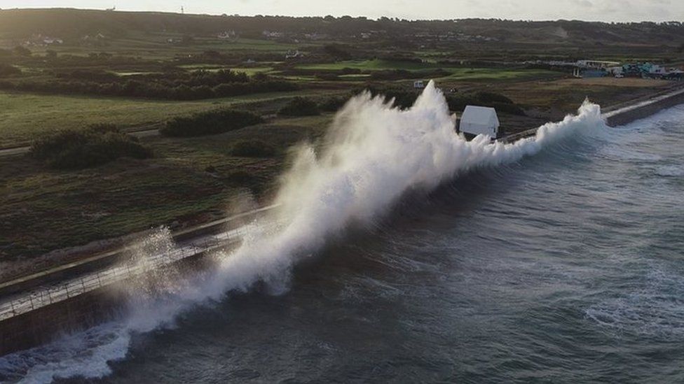 St Ouen's coast with wave crashing onto path