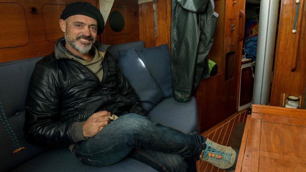 Argentine sailor Juan Manuel Ballestero poses for a picture in the cabin of his sailboat