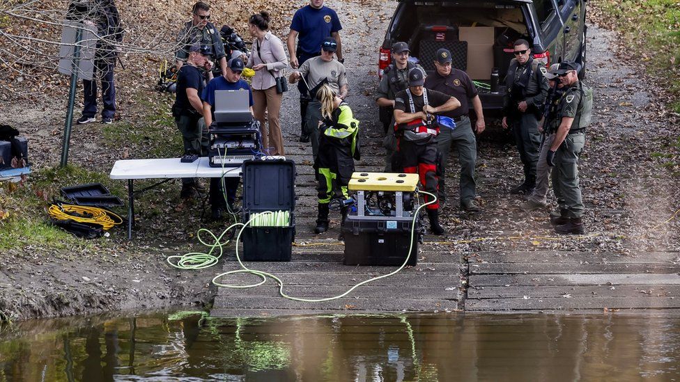 Police put a robot into the water to search the river.
