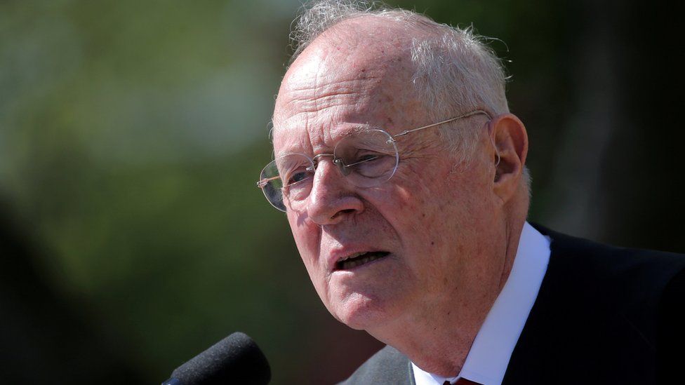 Supreme Court Associate Justice Anthony Kennedy speaks in front of a microphone