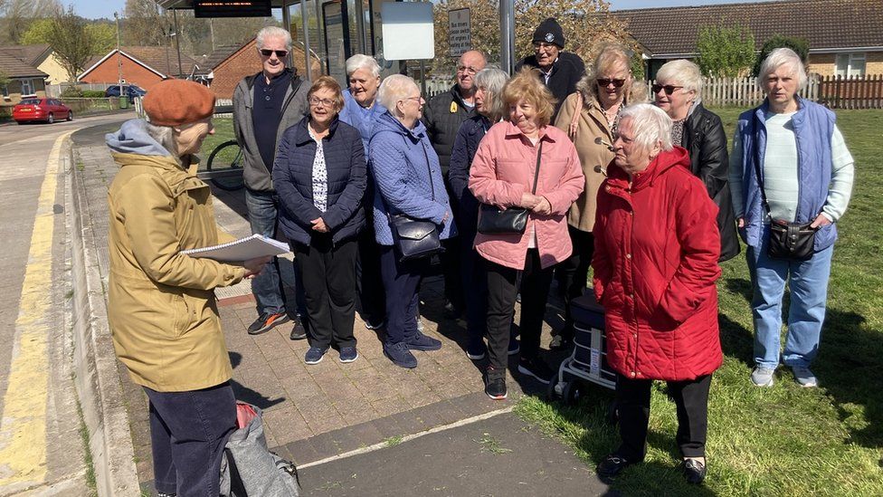 Protesting residents gathered around a bus stop