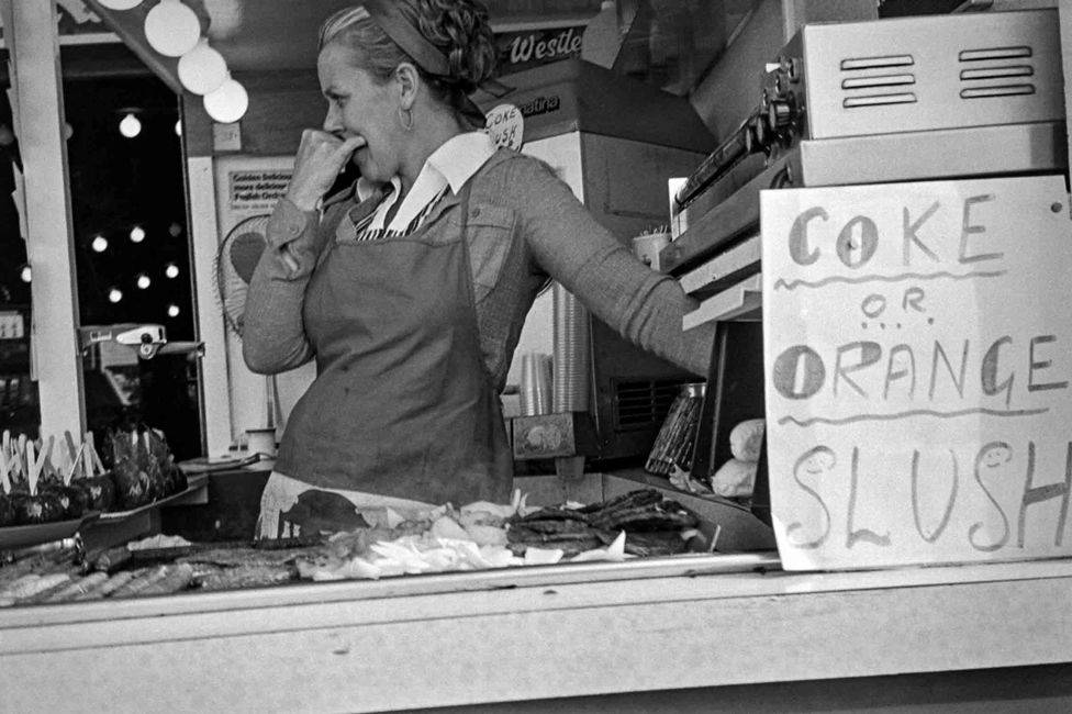A woman at a refreshment kiosk in Rhyl