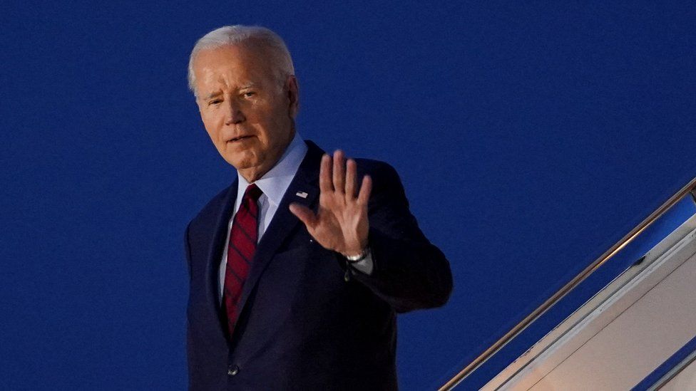 Joe Biden walks down the steps of Air Force One