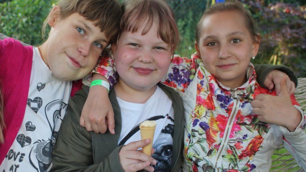 Three girls from Belarus enjoy an ice cream in the UK