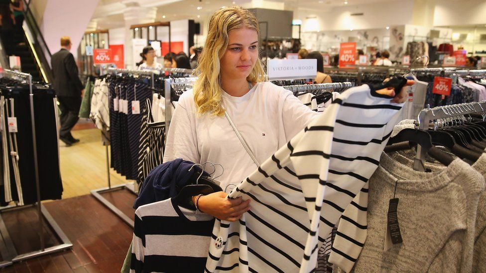 A woman looks at a jumper for sale in a David Jones department store in Sydney