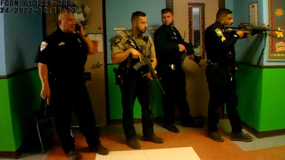 Officers waiting in a hallway