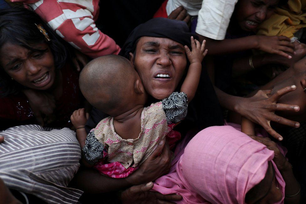 Rohingya Muslims scuffle as they wait to receive relief aid at Kutupalong refugee camp, near Cox's Bazar, Bangladesh.