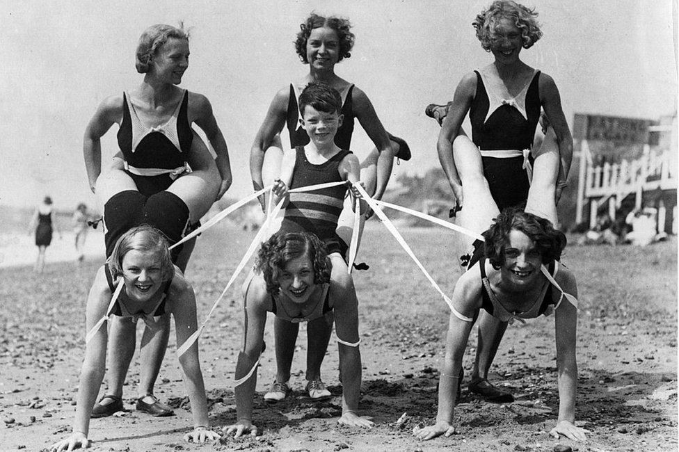 Women and a boy enjoying beach games