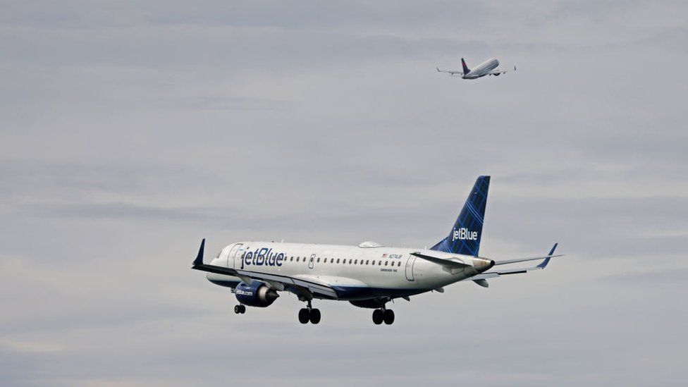 A jetBlue airplane heads in for a landing at Boston Logan International Airport