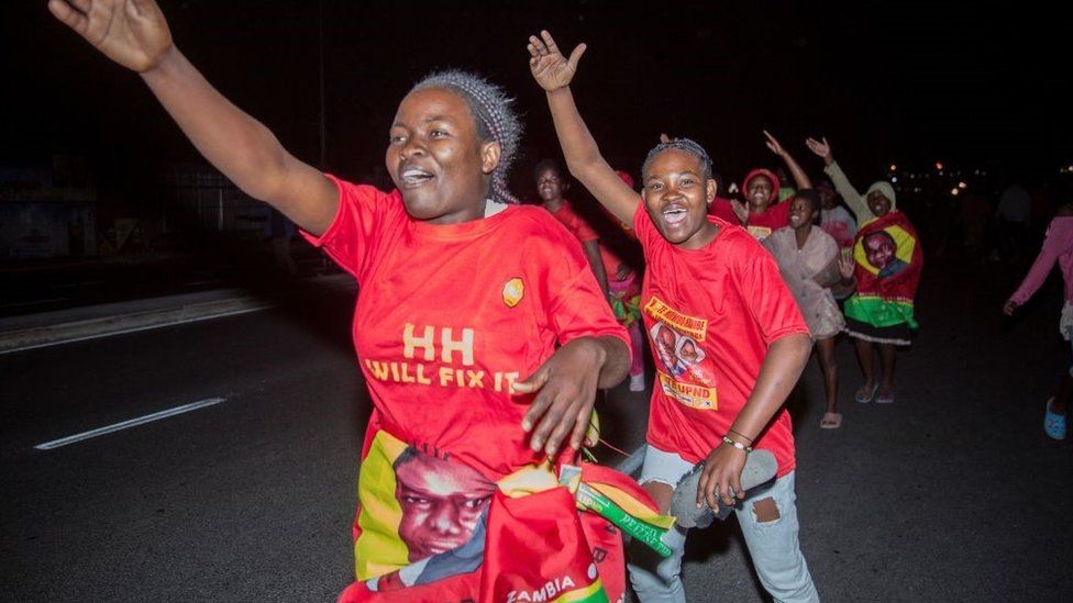 Supporters of Zambian presidential candidate for the opposition party United Party for National Development (UPND) Hakainde Hichilema celebrate his election as Zambian President in Lusaka, on August 16, 2021