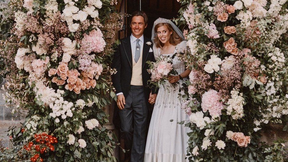 Princess Beatrice and Edoardo Mapelli Mozzi leaving through the flower-covered archway of the Royal Chapel of All Saints at Royal Lodge, Windsor after their wedding