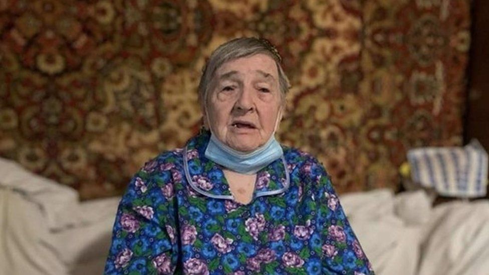 Image shows elderly woman