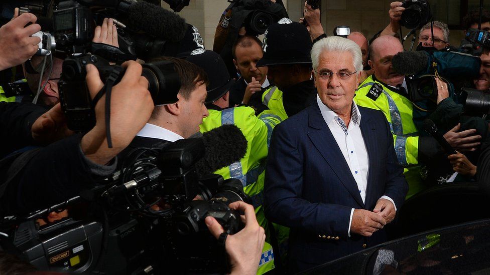 Photographers surround British publicist Max Clifford as he leaves Westminster Magistrates Court in 2013 where he entered not guilty pleas after being charged with 11 counts of indecent assault