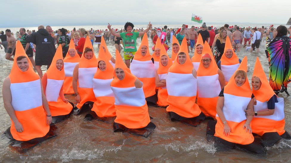 people dressed as traffic cones on beach