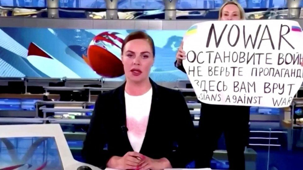 Protester holds anti-war sign on live Russian TV