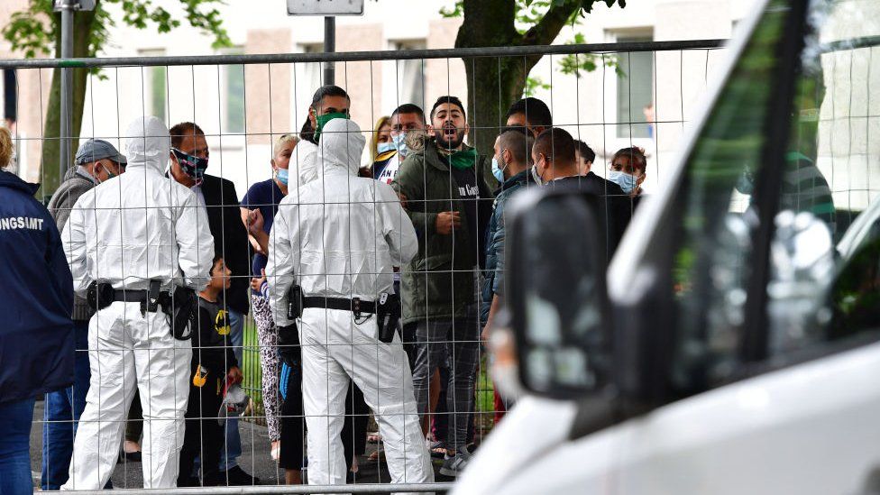 Police outside a German tower block enforcing a coronavirus quarantine