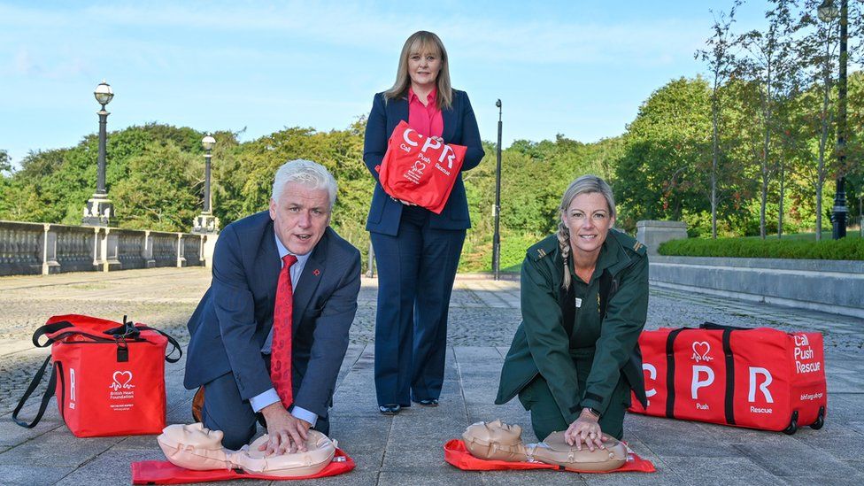 Head of British Heart Foundation Northern Ireland Fearghal McKinney, Education Minister Michelle McIlveen, Northern Ireland Ambulance Service paramedic Stephanie Leckey