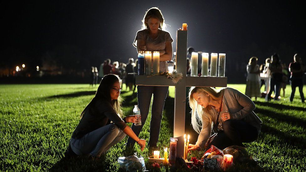 Students attend a candlelight vigil for the victims of a shooting in Parkland, Florida.